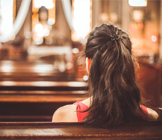 Woman in a church considering CCW insurance for congregation security